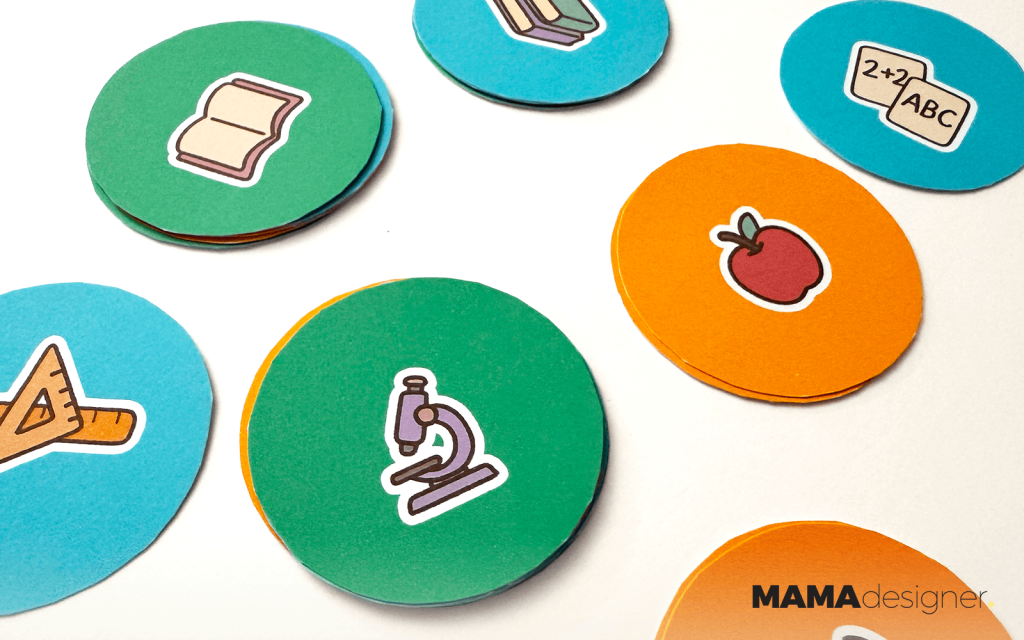 Rozsypane karty do szkolnej gry memory - ilustracje z książką, mikroskopem, jabłkiem i innymi symbolami szkoły