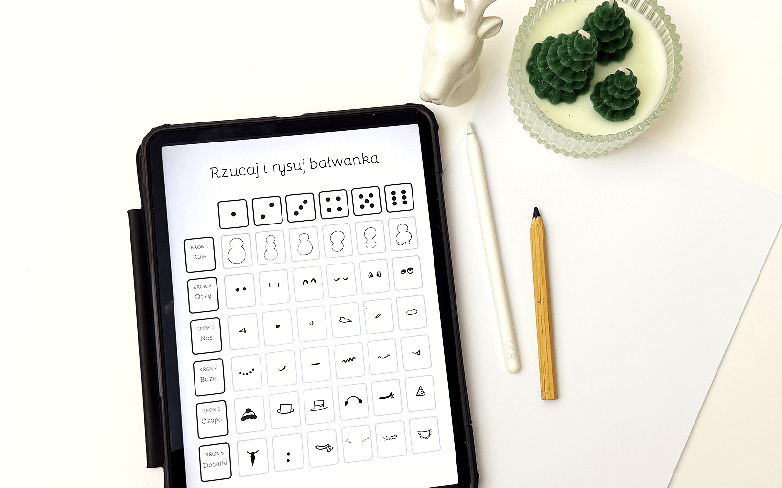 Gra typu "rzucaj i rysuj", wariant z bałwankiem, przedstawiona na ekranie tabletu.